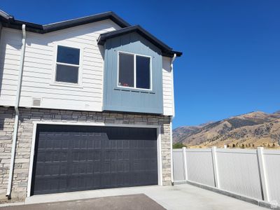 View of side of home with a garage and a mountain view | Image 2