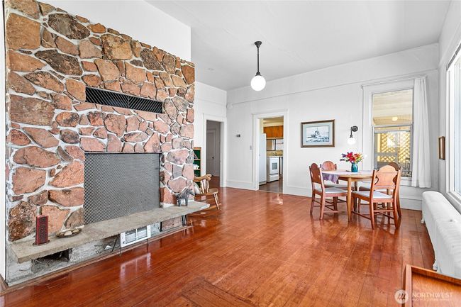 The dining room and living room flank the fireplace - it's a cozy space with an amazing view. | Image 11