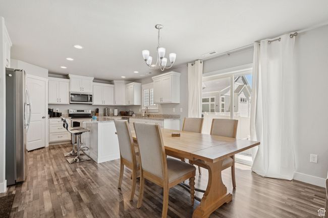 Dining area featuring a chandelier, wood finished floors, and recessed lighting | Image 8