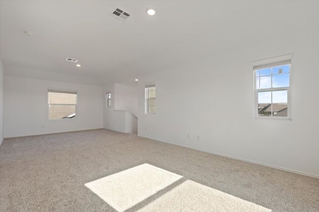 Unfurnished room with light colored carpet, visible vents, and recessed lighting | Image 12