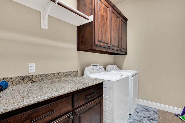 Laundry area with cabinet space, washing machine and clothes dryer, and baseboards | Image 16