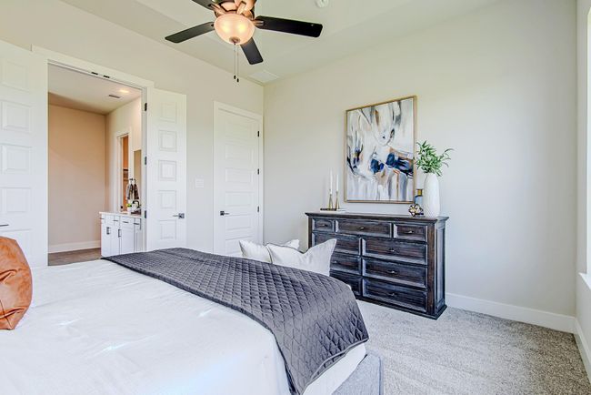 Spacious and stylish, the primary suite offers plenty of room for furniture placement and includes access to a spa-like bath. | Image 23