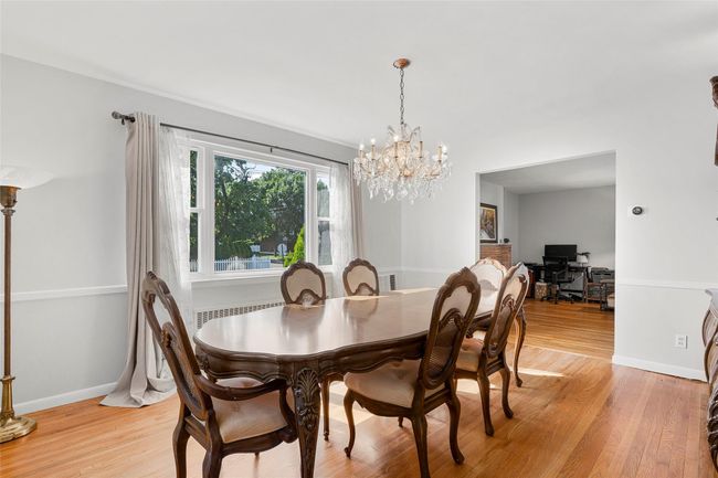 Dining area featuring a chandelier, light wood-type flooring, and baseboards | Image 7