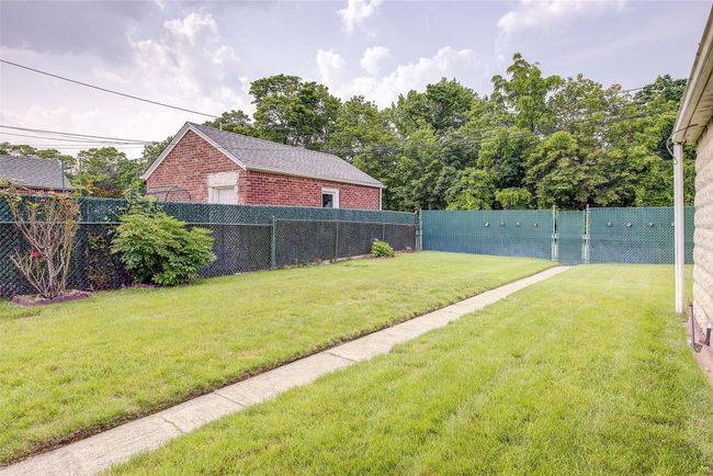 View of fenced backyard | Image 47