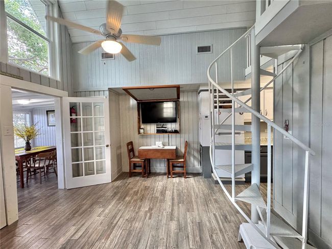 Living room with spiral stairs to loft bedroom | Image 9