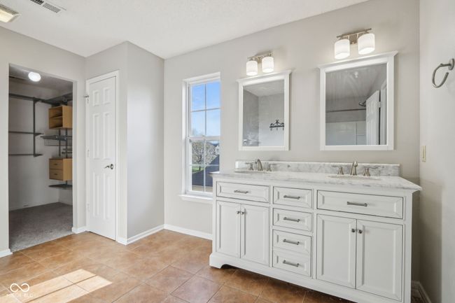 bathroom featuring double vanity, baseboards, and tile patterned flooring | Image 41