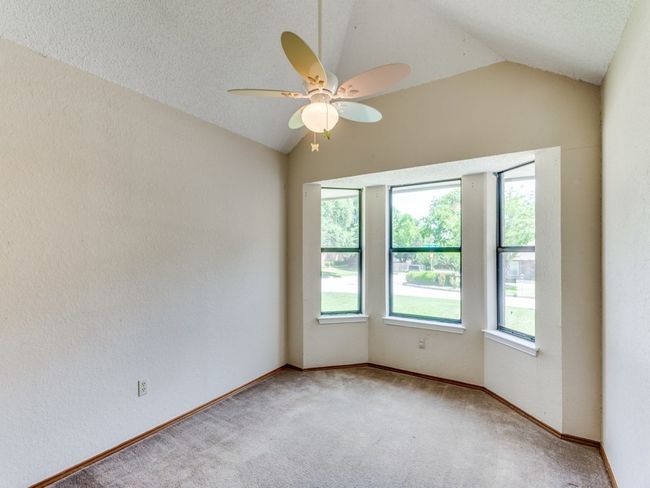 Spare room with vaulted ceiling, a ceiling fan, and carpet flooring | Image 17