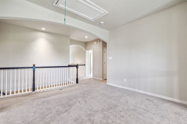 Carpeted spare room with attic access, recessed lighting, baseboards, and arched walkways | Image 30