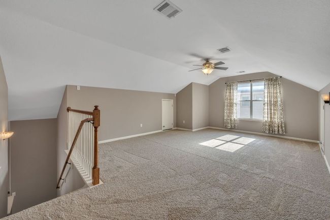 Bonus room featuring ceiling fan, lofted ceiling, carpet floors, and visible vents | Image 18