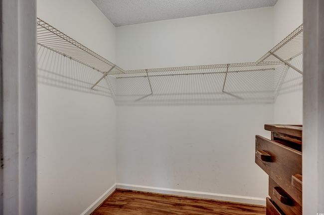 Spacious closet with wood finished floors | Image 28