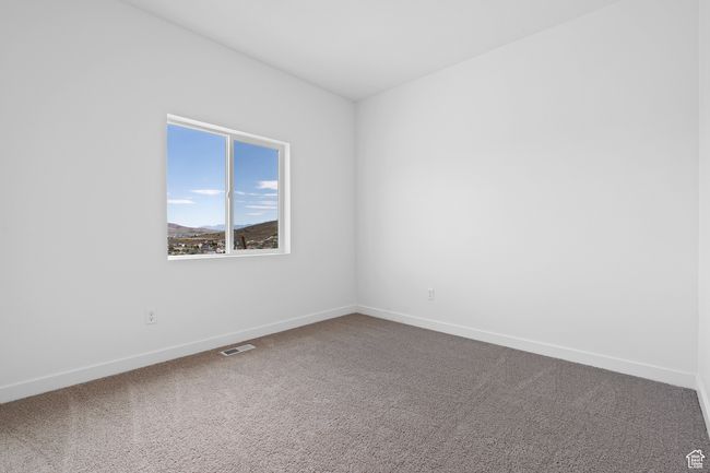 Carpeted empty room featuring visible vents and baseboards | Image 11