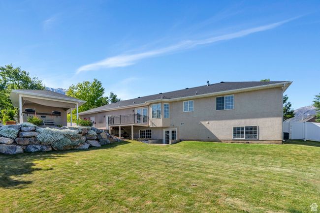 Rear view of house with stucco siding and a deck | Image 28