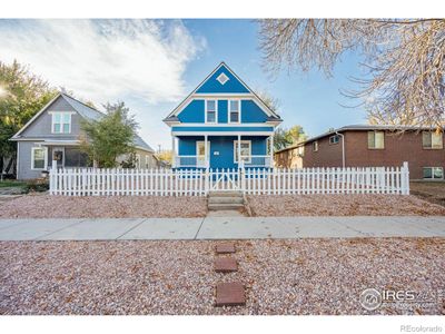 Front view, fresh landscaping, newly painted picket fence | Image 1