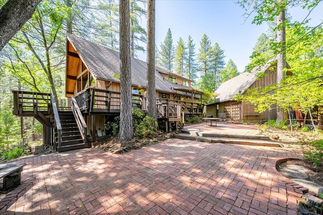Large oaks and pines offer a shaded brick patio space for entertaining guests and outdoor enjoyment | Image 11