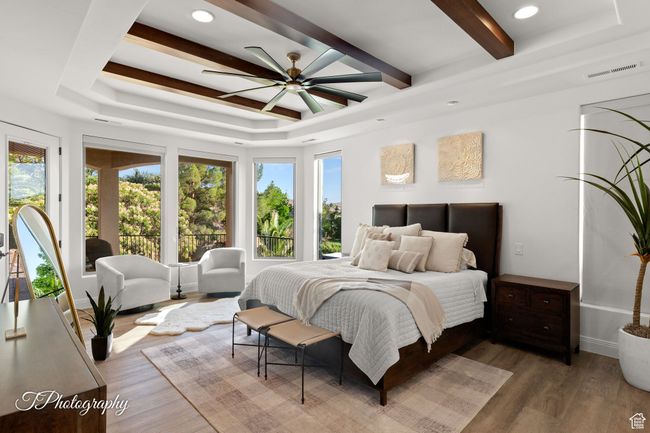 Bedroom featuring wood finished floors, beam ceiling, recessed lighting, baseboards, and a ceiling fan | Image 26