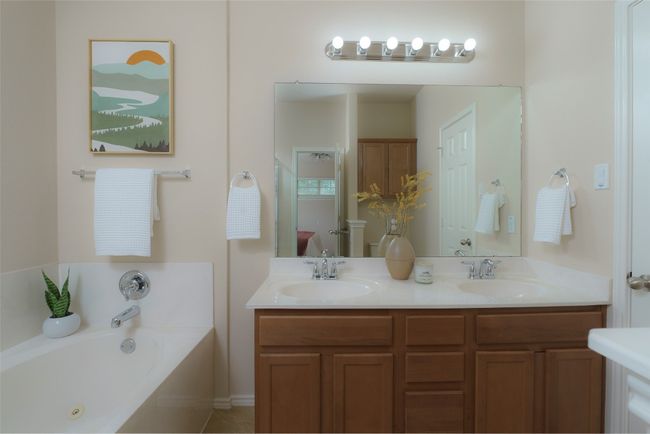 Bathroom featuring a bath, a sink, and double vanity | Image 14