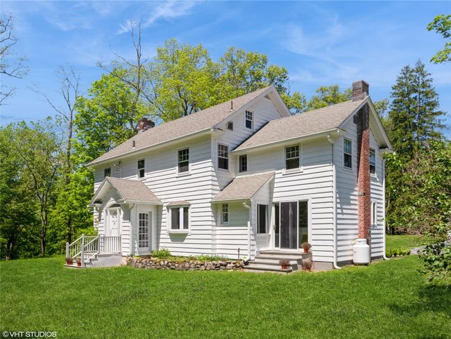 Back of house featuring a chimney, roof with shingles, and a yard | Image 8