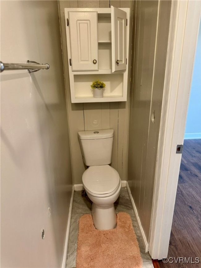 Bathroom with baseboards, toilet, and wood finished floors | Image 17