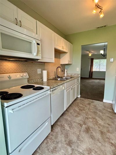 Kitchen was recently remodeled with new cabinets & backsplash. Newly painted throughout. | Image 2