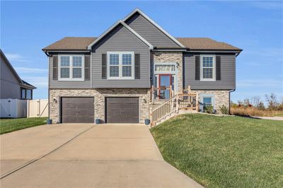 Split foyer home with a garage and a front lawn | Image 1