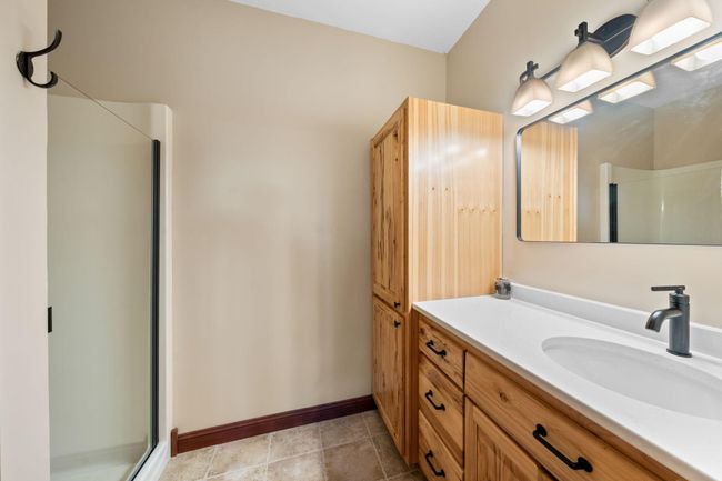 Primary suite 3/4 bath with brand new countertop, faucet, and glass shower door. | Image 19