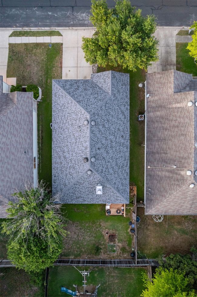 Relax on the covered back patio or deck offering the perfect spot to watch the sunset in your private, fenced in yard. | Image 38