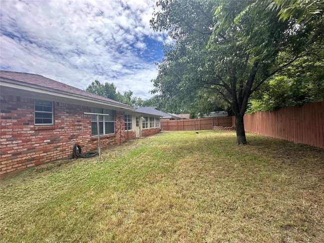 View of fenced backyard | Image 33