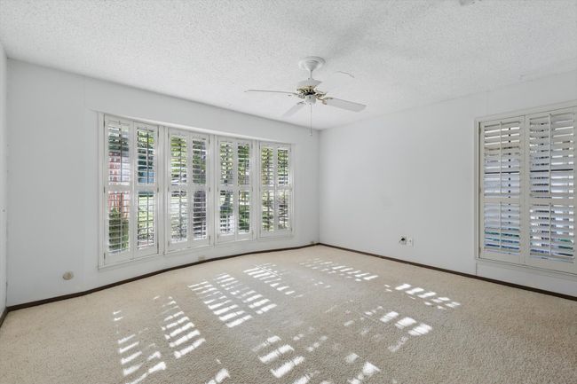 Unfurnished room featuring a textured ceiling, carpet flooring, baseboards, and ceiling fan | Image 22