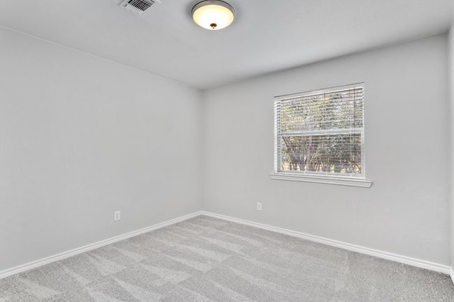 The guest bedroom offers a spacious and inviting space. Both bedrooms overlook tranquil green space. | Image 23