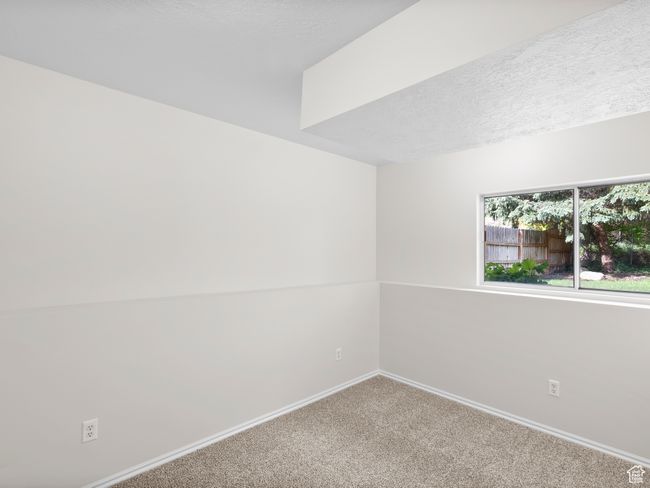 Carpeted empty room with baseboards and a textured ceiling | Image 21