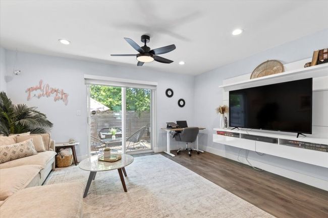 Living room featuring wood finished floors, a desk, a ceiling fan, and recessed lighting | Image 12