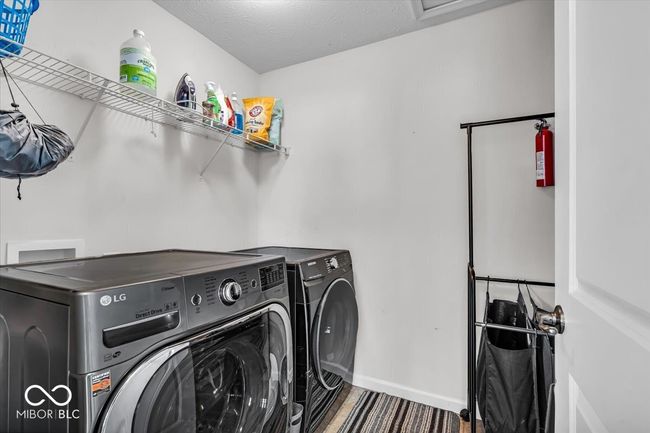 Conveniently located laundry room upstairs with plenty of space for extra cleaning supplies or linens. | Image 28
