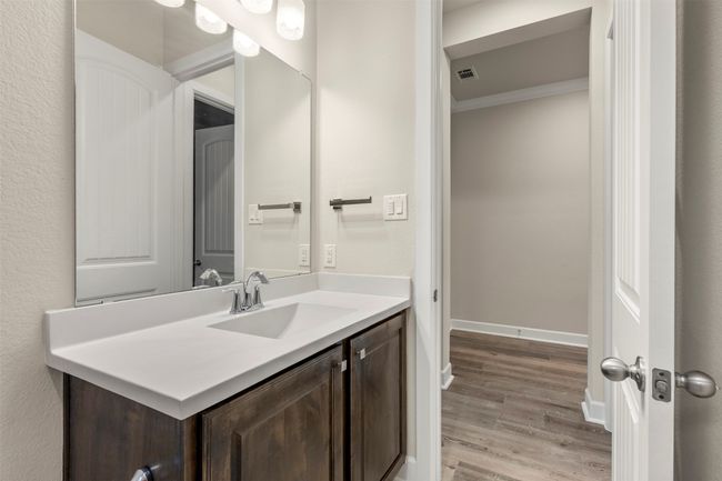 Bathroom with vanity, wood finished floors, ornamental molding, and baseboards | Image 26