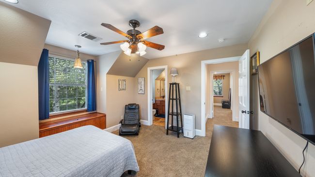 Bedroom featuring baseboards, visible vents, a ceiling fan, and light colored carpet | Image 24