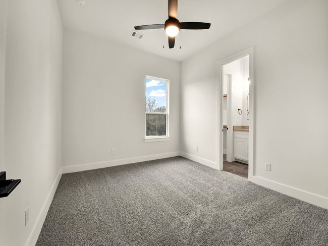 Unfurnished bedroom featuring carpet, ceiling fan, and connected bathroom | Image 20