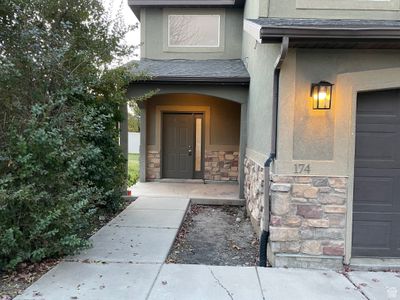 Doorway to property with a garage | Image 2