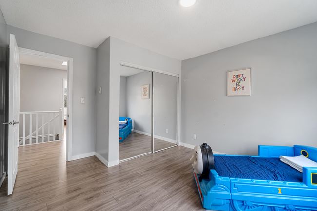Bedroom with a closet, wood finished floors, and baseboards | Image 19