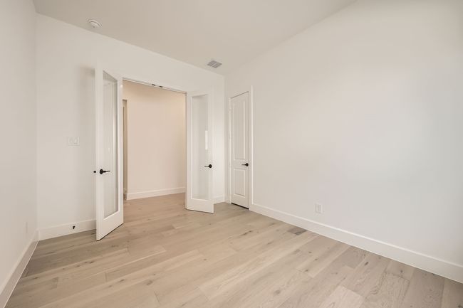 Spare room featuring light wood-type flooring, baseboards, and a smoke detector | Image 16