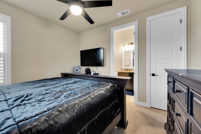 Bedroom with light carpet, ensuite bathroom, and ceiling fan | Image 22