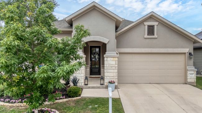View of front of home featuring a garage, stucco siding, driveway, and a shingled roof | Image 37