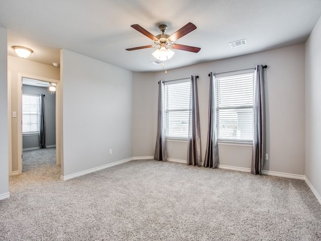 Empty room featuring ceiling fan, carpet, and healthy amount of natural light | Image 10