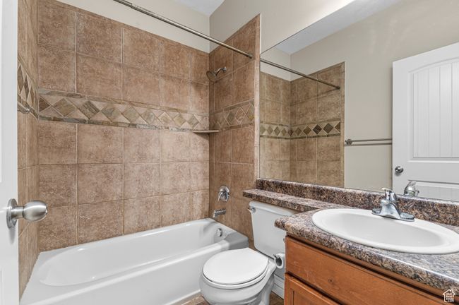 Bathroom with toilet, washtub / shower combination, and vanity | Image 13