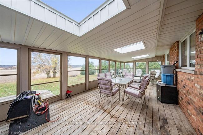 Sunroom / solarium featuring lofted ceiling with skylight | Image 35
