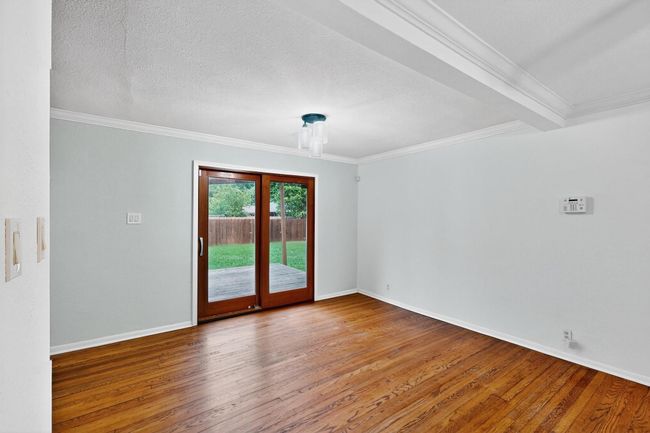 Spare room featuring ornamental molding, hardwood / wood-style flooring, and a textured ceiling | Image 4