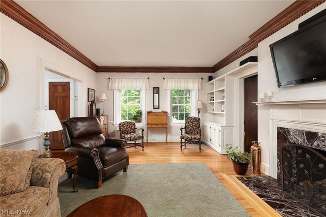 Living room featuring crown molding, a high end fireplace, and hardwood / wood-style floors | Image 18