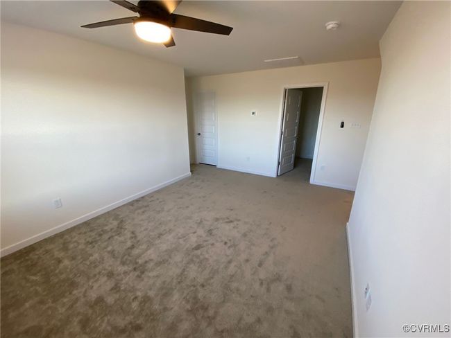 Unfurnished bedroom with baseboards, carpet floors, and a ceiling fan | Image 27