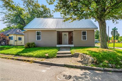 Bungalow-style home with covered porch and a front lawn | Image 2