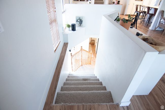 Stairway featuring wood finished floors | Image 26
