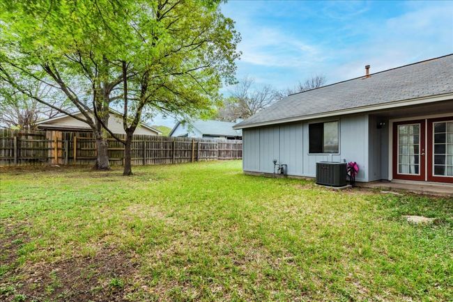 View of yard featuring a fenced backyard and central AC | Image 23