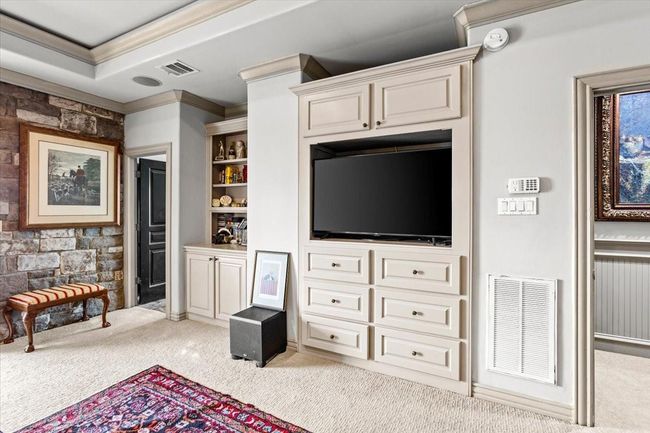 Exposed stone walls, elegant black doors made of solid wood with pewter hardware, and built in cabinets add to the elegance of this bayfront hideaway. | Image 29